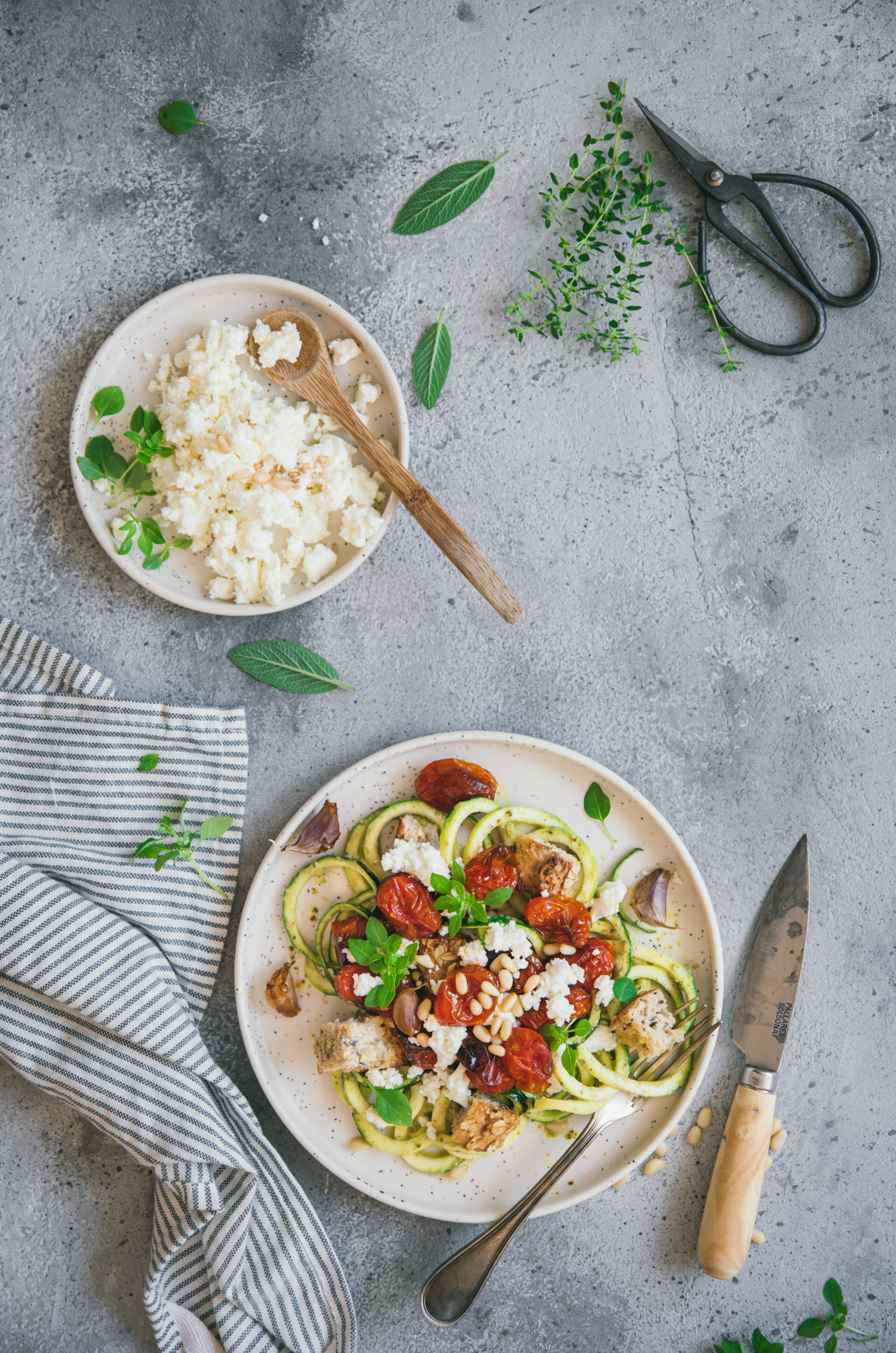 Zucchini spaghetti with pesto, roasted tomatoes and feta cheese